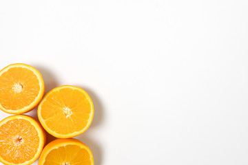 Four half sliced fresh orange in the corner  with white background