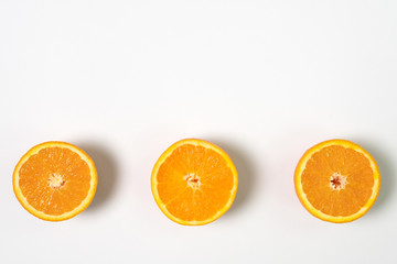 Three half sliced fresh orange with white background