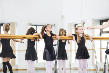 Small beautiful cute girls children in the Studio train with a coach at a dance lesson.