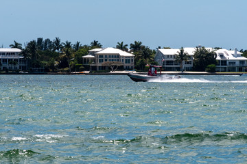 Fototapeta na wymiar Boat At Sanibel Beach With Houses In The Background