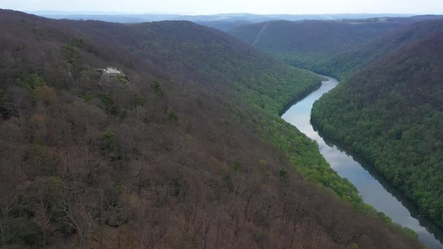 Aerial ascending view of the Coopers Rock overlook with panoramic views of the surrounding mountains and Cheat river.