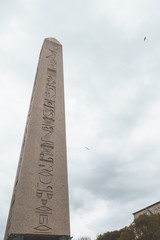 The Obelisk of Theodosius in Sultanahmet Square in Istanbul. Obelisk of Theodosius close-up in gloomy weather. Egyptian hieroglyphics on a large obelisk