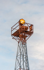 Telecommunication mast with sky background.