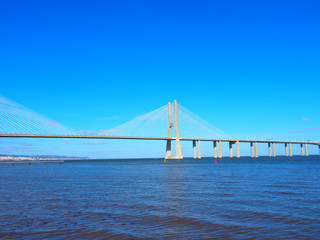 View of the Vasco da Gama Bridge and the Tagus River near the Park of the Nations (Parque das Nações) in Lisbon, Portugal.