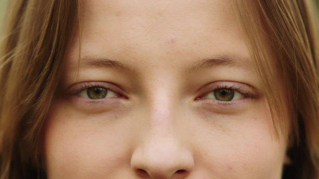 Natural beauty concept. Close up shot of caucasian woman with beautiful green eyes and frekles. Smiling girl