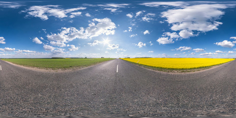 Full spherical seamless panorama 360 degrees angle view on no traffic asphalt road among rapeseed...