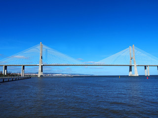 Fototapeta na wymiar View of the Vasco da Gama Bridge and the Tagus River near the Park of the Nations (Parque das Nações) in Lisbon, Portugal.