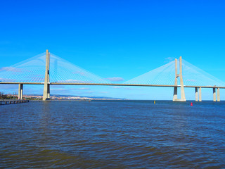 View of the Vasco da Gama Bridge and the Tagus River near the Park of the Nations (Parque das Nações) in Lisbon, Portugal.