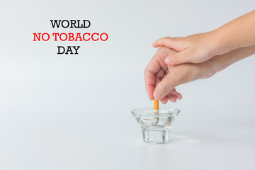 World No Tobacco Day, May 31. Stop Smoking.,Hand of father holding cigarettes, Hand of kid breaking hand of father before smoking cigarette, copy space.