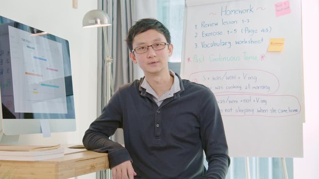 Asian man, young adult teacher or tutor teaching online at home. New normal lifestyle during coronavirus lockdown quarantine. E-learning online remote study, internet education technology concept