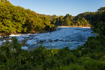 Obraz premium polluted Tiete river on the park road, environmental preservation area, Itu, Sao Paulo, Brazil