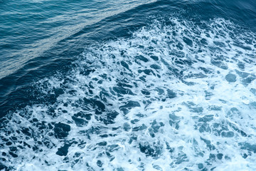 Ocean wave with a cap of sea foam during stormy weather.Abstract. Background.