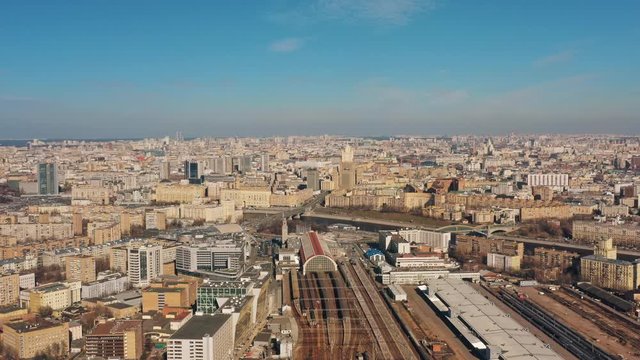 Drone panorama shot of Moscow centre under bright cloudy sky in spring. Slow drone zoom out shot with a panorama view on historical buildings anda railway station
