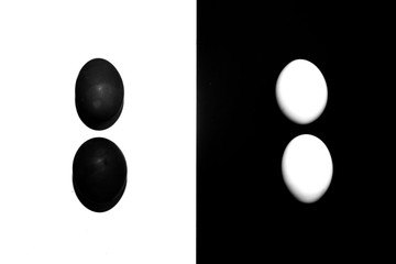 black and white eggs on a white and black background