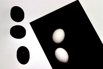 black and white eggs on a white and black background