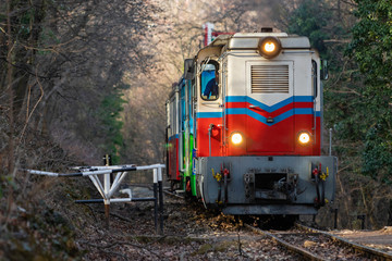 Train is climbing a hill in Huvosvolgy-Budapest on a cold day in February, operated by children