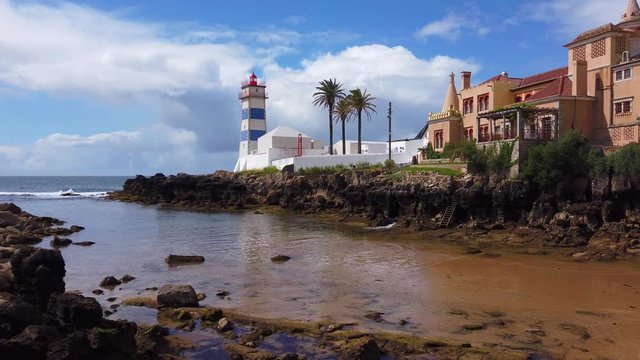 Lighthouse tower with a blue sky in background. Santa Marta Lighthouse in Cascais, Portugal