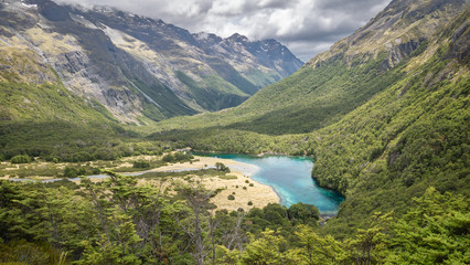 Fototapeta na wymiar Pristine alpine lake hidden in the mountain valley, shot at Blue Lake, Nelson Lakes National Park, New Zealand