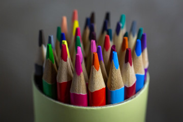 colored pencils in a round tube