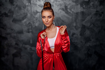 Beautiful girl straightens a red suit.