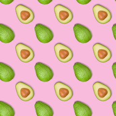 Seamless pattern of green avocado isolated on a pink background. Food background. Flat lay