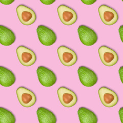 Seamless pattern of green avocado isolated on a pink background. Food background. Flat lay