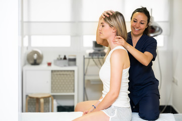 Physiotherapist inspecting her patient in a physiotherapy center.
