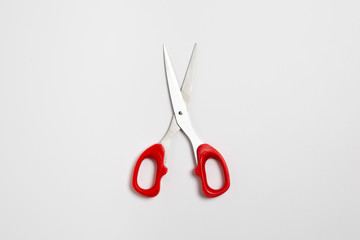Red scissors isolated white background with a clipping path, close up open scissors object. Top view.High-resolution photo.