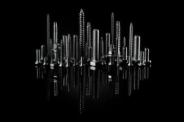 Screws and bolts on a black background. Small self-tapping screws and mounting screws. 