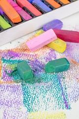  A close up of broken artists soft pastel chalk crayons on an art pad