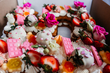 Beautiful fruit cake decoration. strawberries and flowers