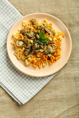pasta in a creamy sauce with spinach on a napkin with a fork.