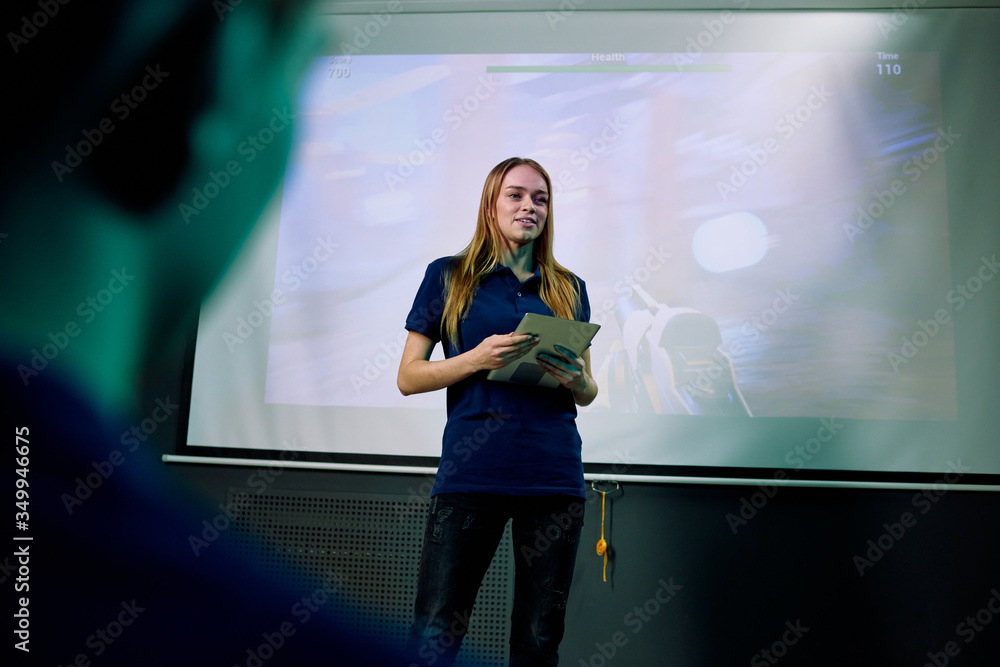 Aufkleber young confident female developer of new network video game with tablet