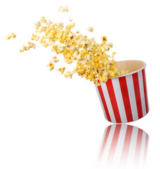 Flying popcorn from paper striped bucket isolated on white background - obrazy, fototapety, plakaty