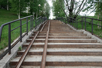 A long multi-arched staircase in the Park, equipped with a ramp for the descent and ascent of children's and wheelchairs. Selective focus.