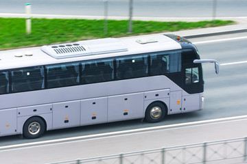 Large comfortable long-distance bus rides on the highway.