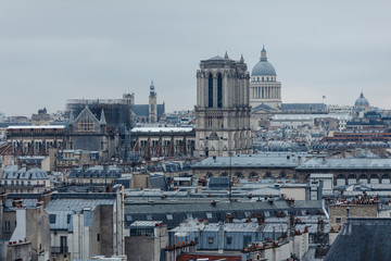 Fototapeta na wymiar View of the Parisian roofs and towers of Notre Dame.