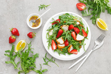 Strawberry salad with arugula and chicken meat