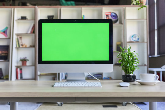 Computer Desktop With Mock-up Green Screen White Background In Office And Lovely Plant In Black Pot