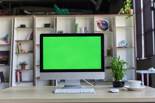 Computer Desktop With Mock-up Green Screen White Background In Office And Lovely Plant In Black Pot