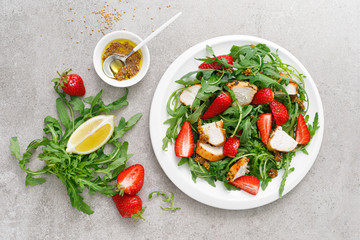 Strawberry salad with arugula and chicken meat