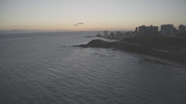 Aerial Hyperlapse of waves breaking by the shore during sunset in Salvador Bahia in Brazil