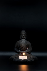 Sitting Buddha Statue with a candle light