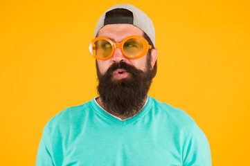 Eyes health. Eyesight check ups. Good vision. Fun and entertainment. Funny accessory. Man eyewear model. Funny sunglasses. Bearded man in sunglasses orange background. Hipster wear party sunglasses