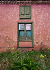 old window in a brick wall of red abandoned house