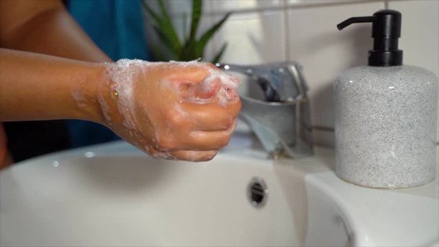 Woman washing hands at home, video