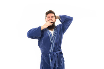 Feeling sleepy. Sleepy hipster yawn isolated on white. Bearded man look sleepy in bathrobe. Early morning time. Good night. Home clothing. Awakening. Being lazy and sleepy