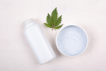 Beauty,Ñosmetics with  marijuana. Ñream and cannabis leaf on a white background