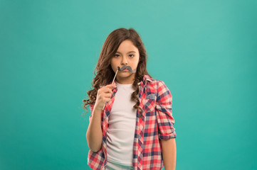 serious kid with funny party moustache. school girl ready for fun. happy childhood. child try to make positive mood. looking funny with mustache. small girl prefect casual fashion