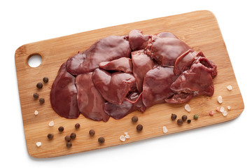 Raw chicken livers on on a wooden cutting board on white background.